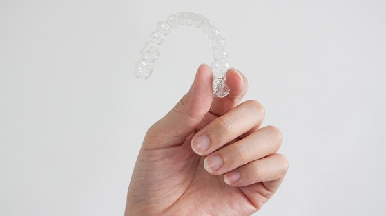 Patient holding clear aligner