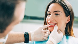 Cosmetic dentist in Wakefield looking at patient's smile