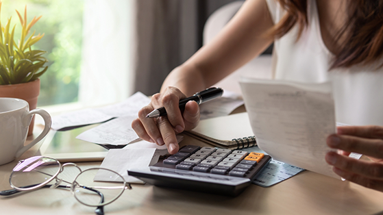 Woman typing on a calculator