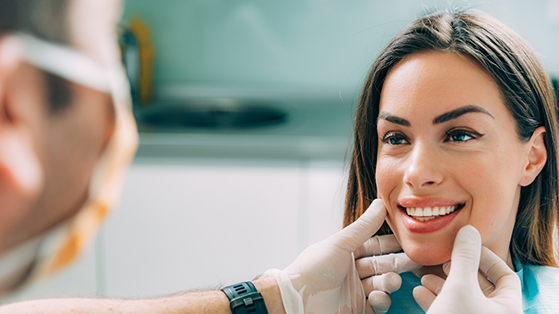 Woman smiling at her cosmetic dentist