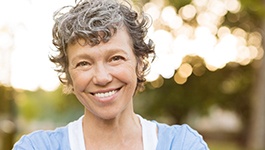 woman smiling while standing outside