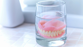 full dentures in a glass of water