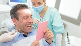 dental professional holding dentures 