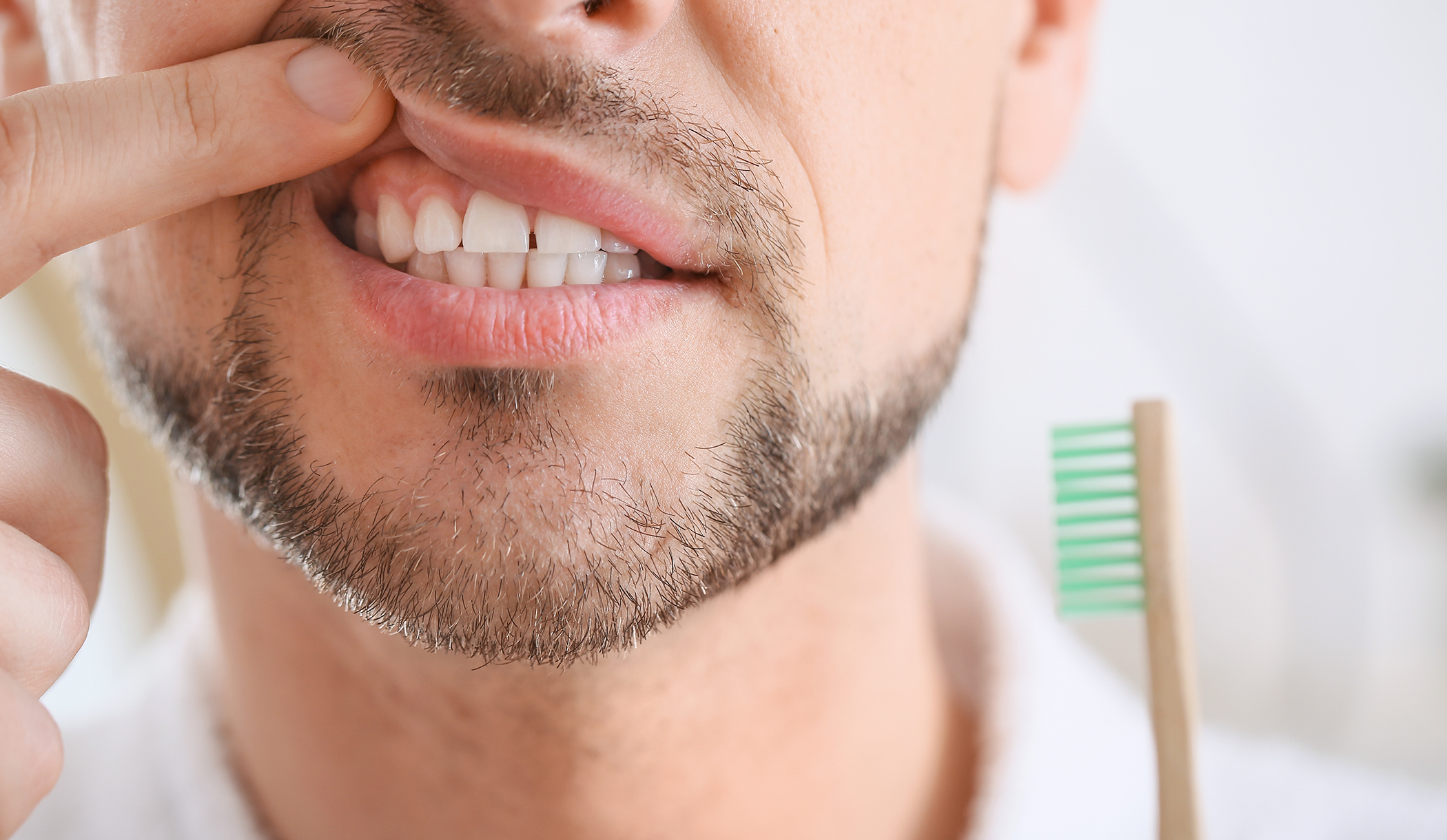 Man pointing to his gums