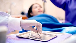 dentist reaching for tools 