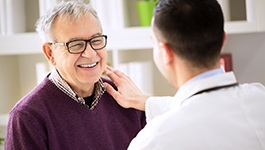 Man smiles at his dentist