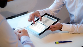 Patient reviewing dental insurance forms with office manager