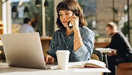 Woman talking on phone at coffee shop