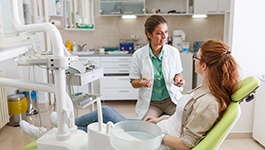 Dentist and patient talking in treatment room