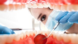 Dentist giving a patient an oral cancer screening in Wakefield