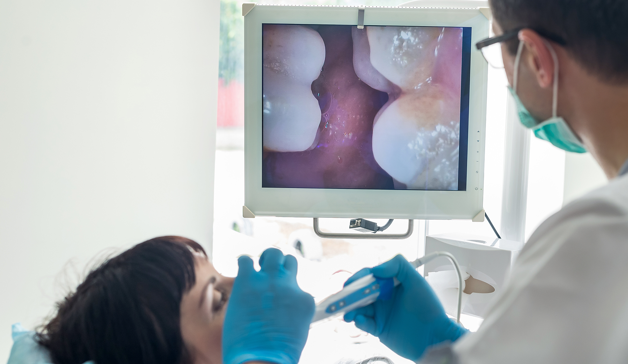 Woman getting an oral cancer screening from her dentist in Wakefield