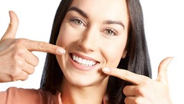 woman pointing to teeth