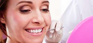 dentist checking woman's teeth