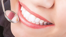 Close up of dental mirror checking teeth