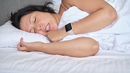 a woman grinding her teeth while she’s sleeping