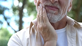 a man holding his jaw 