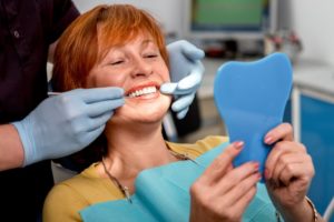 A woman examining her smile.