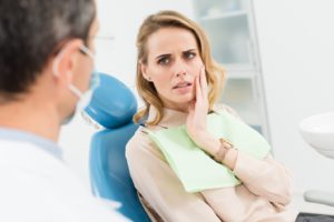 Woman visiting her emergency dentist because of a chipped tooth.