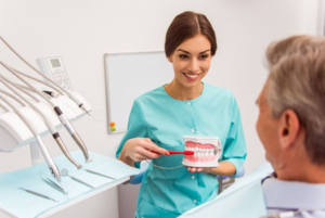 a patient receiving dentures from their dentist