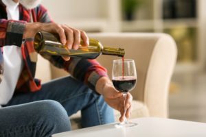 Senior man pouring a glass of wine